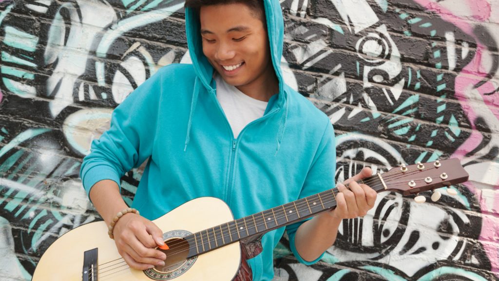 Composition & Songwriting, Male Student with Acoustic Guitar